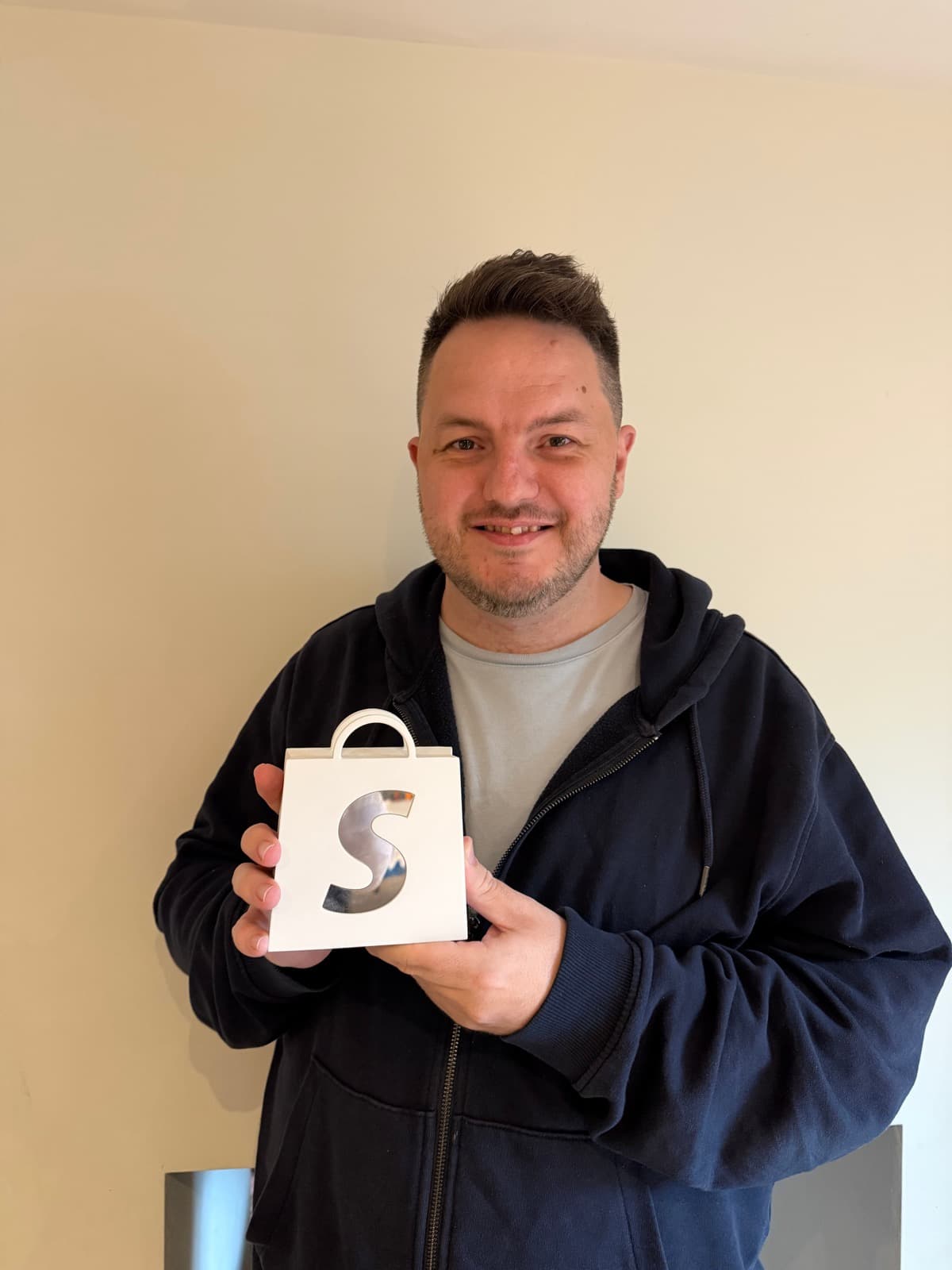 Dean Keating holding his Shopify 10K Award